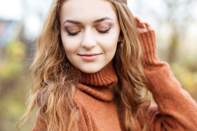 Beautiful girl in cinnamon coat in autumn